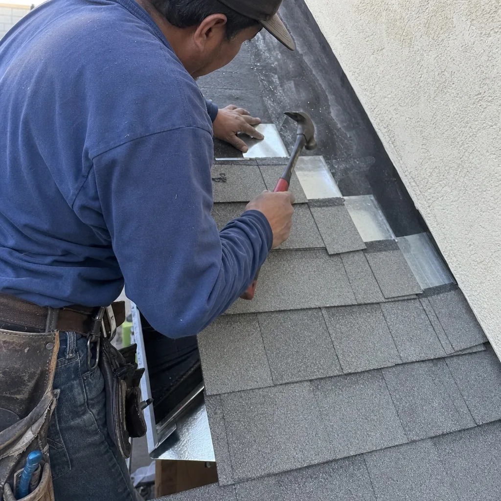 Professional roofer installing asphalt shingles on a roof